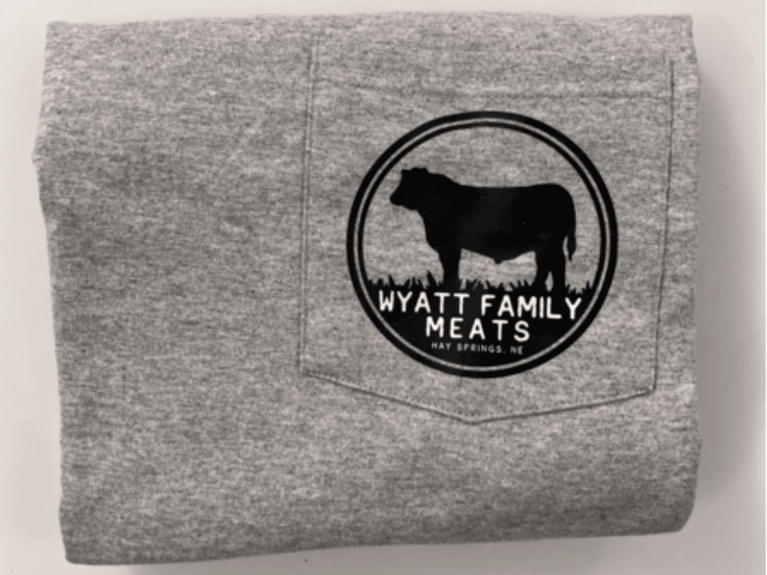 Screenshot+2025-09-08+at+2.06.38 PM Gray t-shirt featuring the "Wyatt Family Meats" logo with a cow silhouette, sourced from Hay Springs, NE, showcasing family-owned meat business branding.
